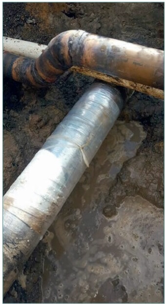 Figure 1. Copper fire main rerouted through a series of 45 degree bends and the insulation repair to the gas main.