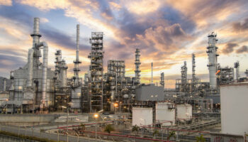 Oil and gas industrial zone: The equipment and industrial pipelines of a large oil refinery plant.