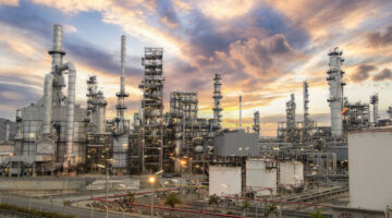 Oil and gas industrial zone: The equipment and industrial pipelines of a large oil refinery plant.