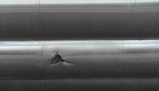 Mechanical damage on a steel pipe, which in turns leads to material failure such as brittle cleavage fractures.